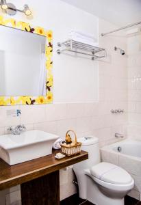 a bathroom with a sink and a toilet and a mirror at Alwa Hotel Boutique Premium in Arequipa +31 photos