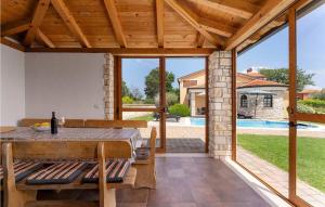 a patio with a table and chairs and a pool at Villa Morena in Buje