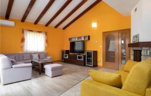 a living room with a couch and a tv at Villa Morena in Buje