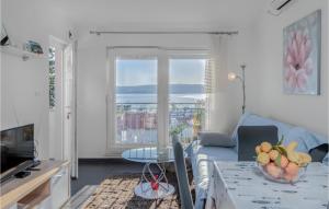 a living room with a blue couch and a table at Awesome Apartment In Crikvenica in Crikvenica