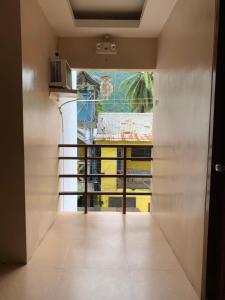 an open door to a balcony with a view at Francis Dale Lodge L3 in El Nido