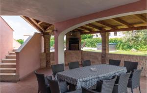 a patio with a table and chairs and a staircase at Gorgeous Home In Nova Vas in Nova Vas