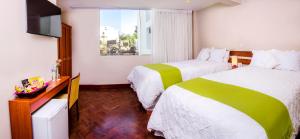 a hotel room with two beds and a television at Alwa Hotel Boutique Standard in Arequipa +20 photos