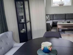 a coffee cup sitting on a table in a living room at 4 person holiday home in Borhaug in Borhaug +32 photos