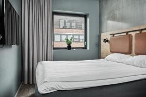 Postel nebo postele na pokoji v ubytování Smarthotel Bodø