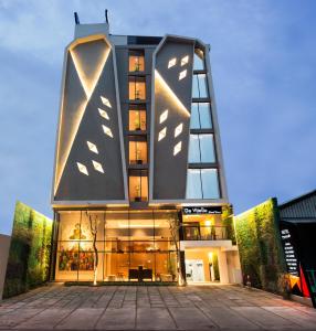 a tall building with a lot of windows at Yellow Star Ambarukmo Hotel in Yogyakarta