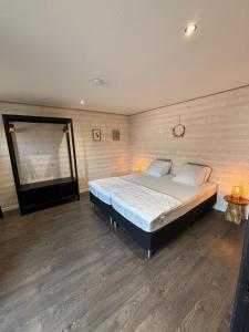 a bedroom with a large bed in a room at Ambiance boisée Moustier in Stoumont +24 photos