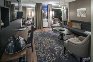 a living room with a couch and a table at Lapland Hotels Oulu in Oulu