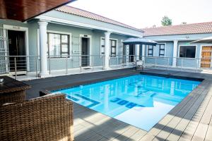 an image of a swimming pool in a house at Papiano Boutique Hotel in Bloemfontein