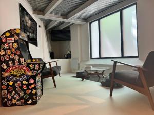 a living room with a skateboard on the wall at Rooms Buttes Chaumont Chambres Buttes Chaumont in Paris