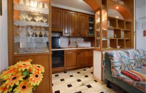a kitchen with wooden cabinets and a sink and a couch at Casa Di Carlo in Acquedolci +9 photos
