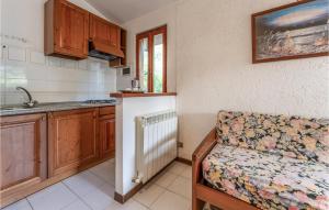a kitchen with a couch and a sink in a room at Poiana in Orbetello