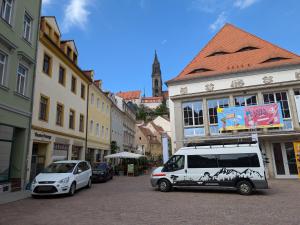 a white van parked on a street in a city at Appartement Napoleon in Meißen