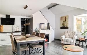 a kitchen and dining room with a table and chairs at 3 Bedroom Awesome Home In Stavenisse in Stavenisse