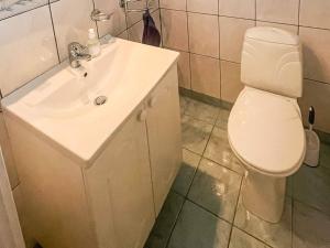 a bathroom with a white sink and a toilet at 12 person holiday home in Davik in Davik +76 photos
