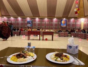 two plates of food on a table in a room at Royal Desert View Camp in Wadi Rum