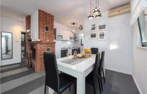a kitchen and dining room with a table and chairs at Lovely Home In Mandre With Kitchen in Mandre