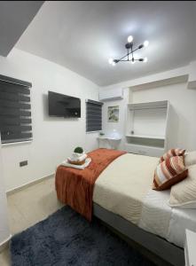 a bedroom with a large bed and a flat screen tv at DG Divine Garden Tabasco in Villahermosa