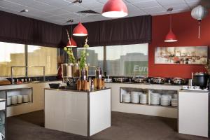 a kitchen with a counter with pots and pans at Best Western Hobart in Hobart