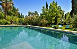 a swimming pool in a yard with trees at Five Bedroom Gorgeous Home In Tarascon in Tarascon