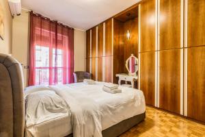 een slaapkamer met een groot bed en houten kasten bij Milano Via Morgantini 5 PAX Wi-Fi in Milaan
