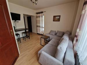 a living room with a couch and a table at Willa Justynka in Krynica Zdrój