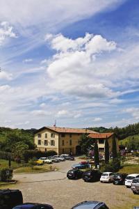 Vezzano sul CrostoloPodere Elisa的建筑物前停放汽车的停车场
