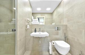 a bathroom with a sink and a toilet at Pytloun Bristol Residence Prague in Prague +73 photos