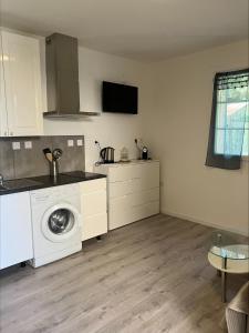a kitchen with a washing machine in a room at Villa Thyziri in Roquefort-les-Pins