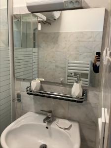 a person taking a picture of a bathroom sink at Villa Thyziri in Roquefort-les-Pins