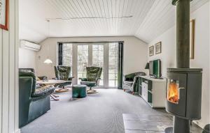 a living room with a fireplace and a table and chairs at Holiday Home Nørballevej Blåvand I in Ho