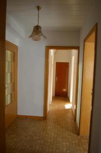an empty hallway with a tile floor and a ceiling at Ferienwohnung Lenchen in Medebach +12 photos