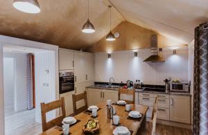 a kitchen with a wooden table and a dining room at Lodge 11 in Wareham