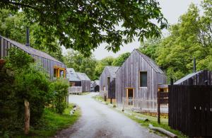 a dirt road lined with houses and a fence at Lodge 11 in Wareham