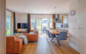 a kitchen and living room with a table and a couch at Wieringen Waddenlodge in Den Oever