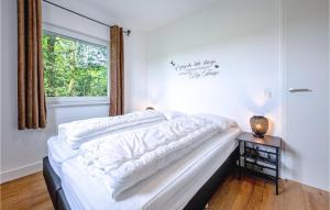 a bedroom with a bed with white sheets and a window at Wieringen Waddenlodge in Den Oever +26 photos