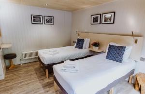 En eller flere senge i et værelse på Lodge 7 + 21 billeder