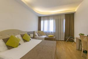 Postel nebo postele na pokoji v ubytování Hotel Boomerang Roma