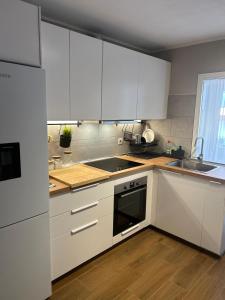 a kitchen with white cabinets and a sink at Calm House in Arona