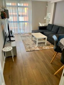 a living room with a couch and a table at Calm House in Arona