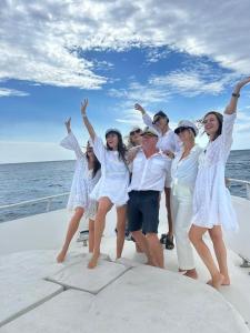 a group of people in white on a boat at Sail & Stay in Castillo de Sabinillas