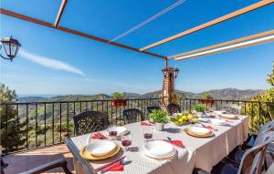 a table on a balcony with a view of the mountains at 7 Bedroom Stunning Home In Frigiliana in Acebuchal