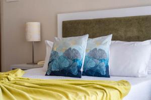 two pillows sitting on top of a bed at Residencial Clássico in Vila Real