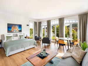 a bedroom with a bed and a living room at Mainzauber Apartments Miltenberg in Miltenberg
