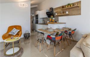 a kitchen and dining room with a table and chairs at Cozy Apartment In Banjole in Banjole