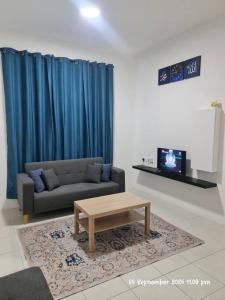 a living room with a couch and a coffee table at Kamilia Homestay Anderson Ipoh in Kampong Simee