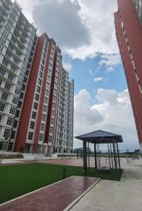 a gazebo in front of two tall buildings at Kamilia Homestay Anderson Ipoh in Kampong Simee +5 photos