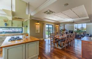 a kitchen and dining room with a table and chairs at Beautiful Home In Banjole in Banjole