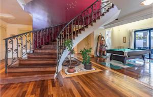a home with a staircase and a pool table at Beautiful Home In Banjole in Banjole