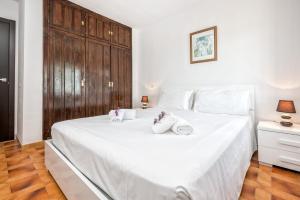 a bedroom with a large white bed with towels on it at F04 Bahia Playa - Apartment in Mijas Costa +31 photos